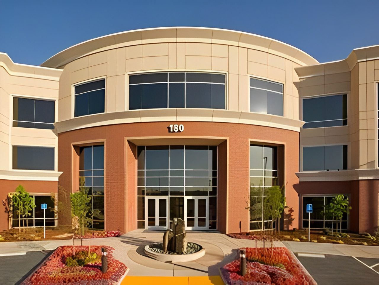 A large building with a fountain in front of it.