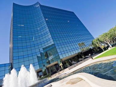 A large building with many windows and a fountain.